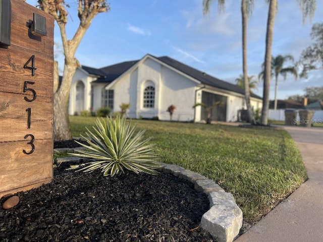 view of property exterior with a lawn and an attached garage