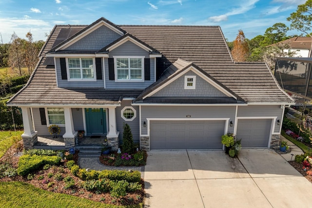 craftsman-style home with stone siding, concrete driveway, and an attached garage