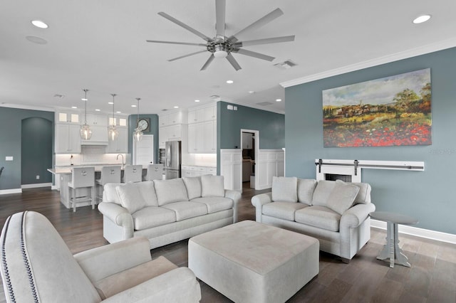 living room with visible vents, ornamental molding, dark wood-type flooring, and recessed lighting