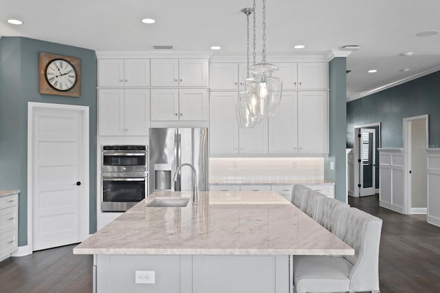 kitchen featuring white cabinets, dark wood-style floors, stainless steel appliances, and a sink