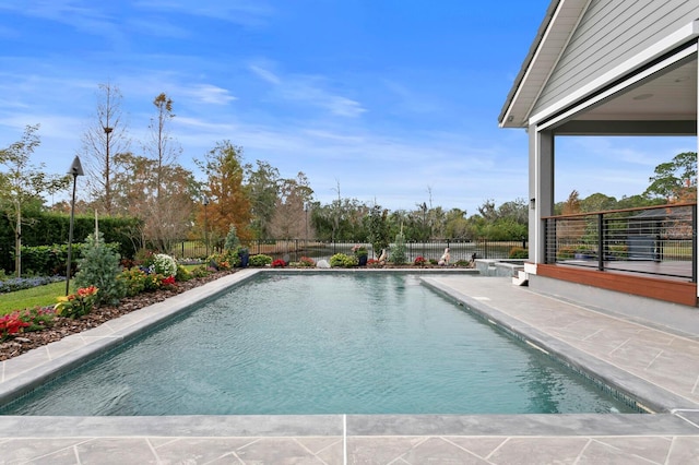 view of swimming pool with a patio area, fence, and a fenced in pool