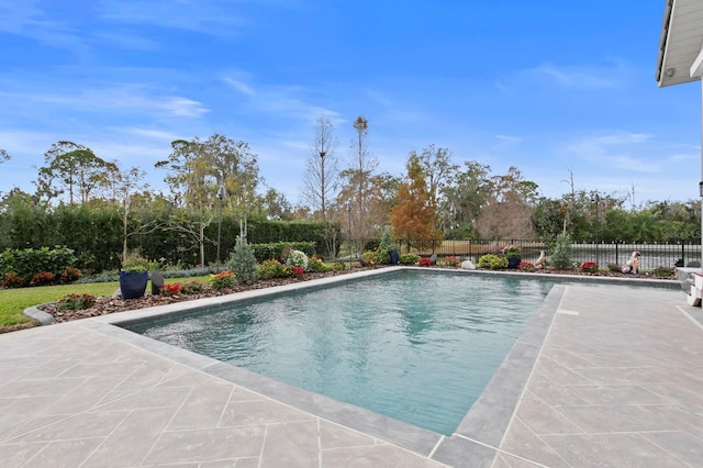 view of swimming pool featuring a fenced in pool, a patio area, and fence