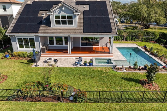 rear view of house featuring a fenced in pool, a patio area, a lawn, and a fenced backyard