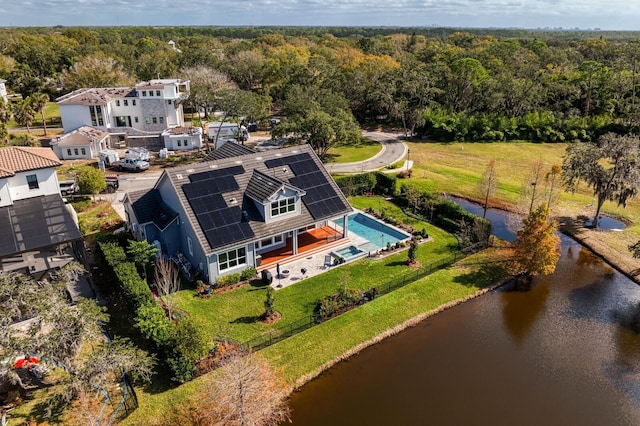 drone / aerial view featuring a water view and a wooded view