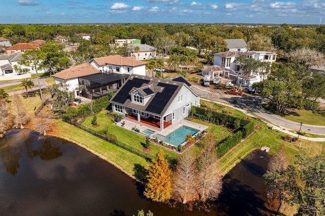 bird's eye view with a water view and a wooded view