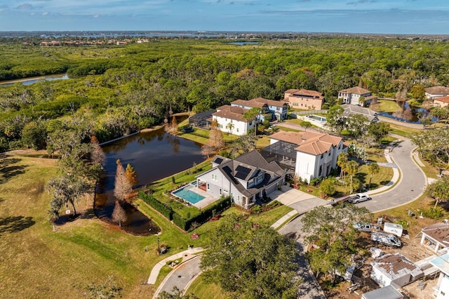 bird's eye view with a water view and a wooded view