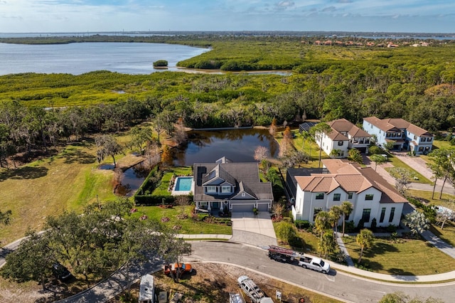 aerial view with a residential view, a water view, and a forest view