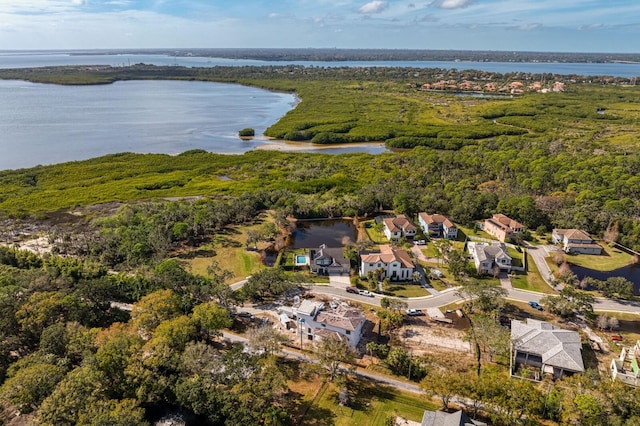 bird's eye view featuring a forest view, a water view, and a residential view