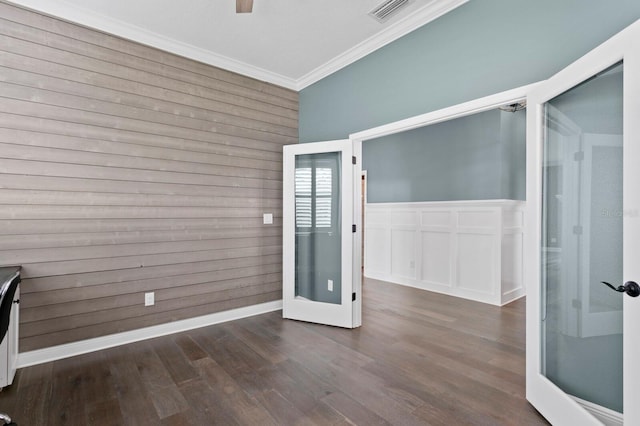 empty room with ornamental molding, french doors, dark wood finished floors, and visible vents