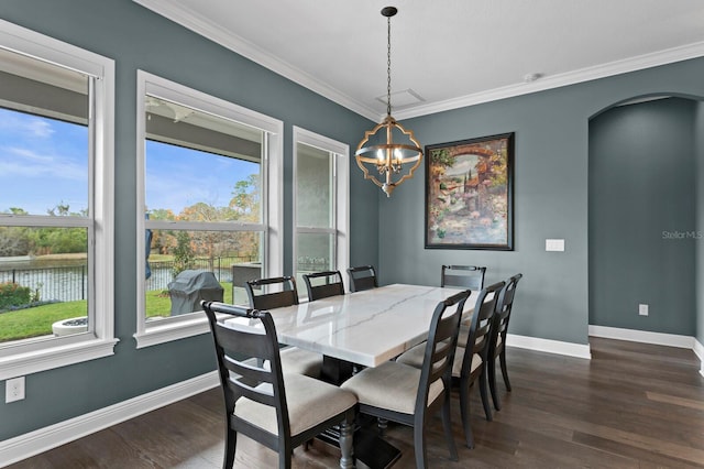 dining area with dark wood-style floors, baseboards, and crown molding