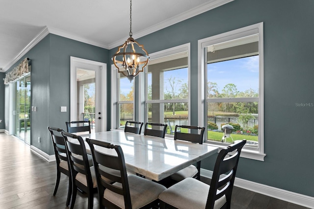 dining room featuring crown molding, dark wood-type flooring, and baseboards