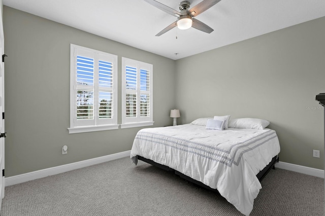 carpeted bedroom with a ceiling fan and baseboards