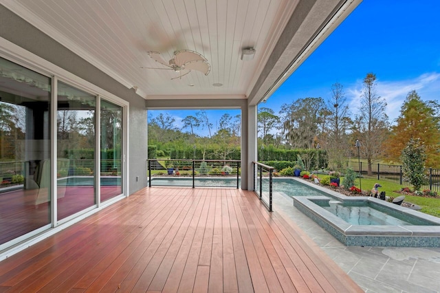 deck featuring ceiling fan, an in ground hot tub, and fence