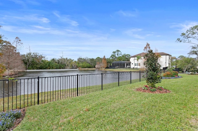 view of yard featuring a water view and a fenced backyard