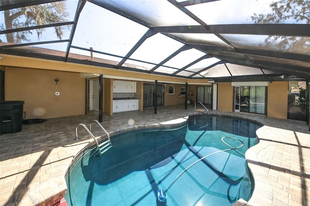 outdoor pool with a lanai and a patio