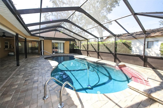 pool with glass enclosure and a patio