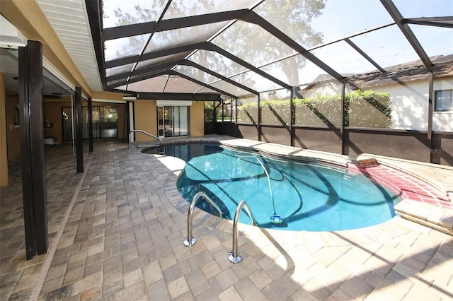 pool with glass enclosure and a patio