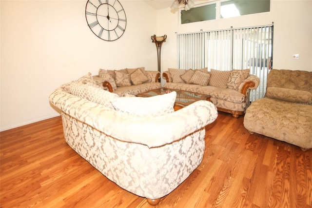 living area featuring baseboards and wood finished floors