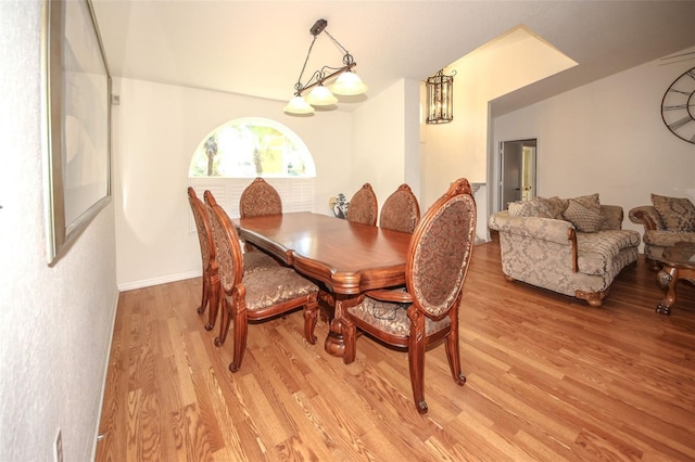 dining room featuring light wood-style flooring and baseboards