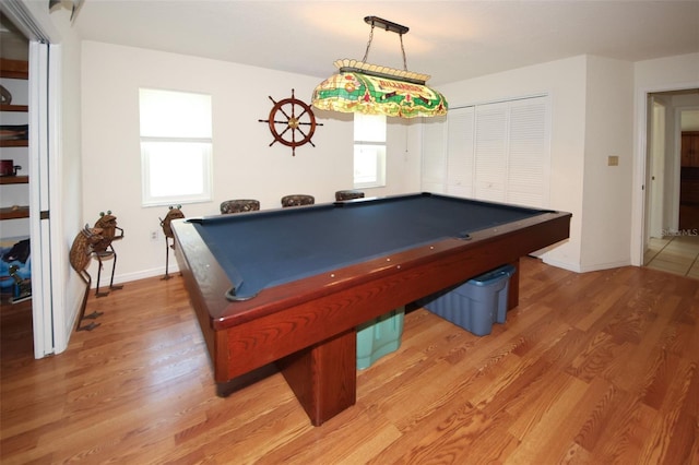 rec room featuring light wood-type flooring, a healthy amount of sunlight, and baseboards