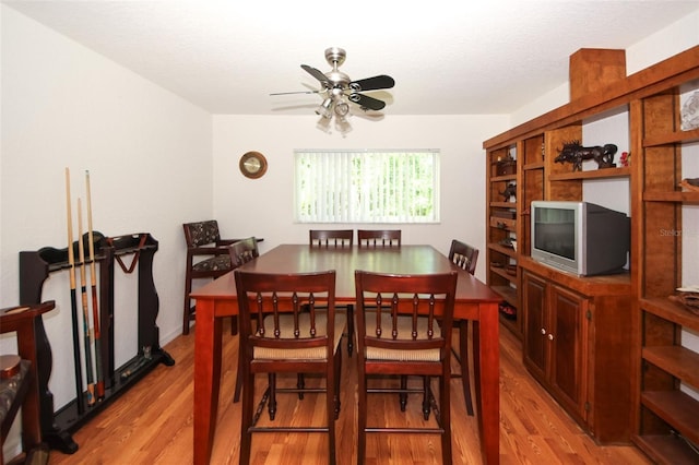 dining area featuring ceiling fan, a textured ceiling, and light wood-type flooring