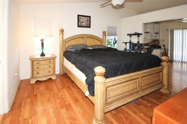 bedroom with vaulted ceiling and light wood finished floors