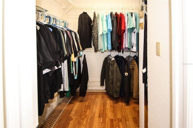 walk in closet featuring wood finished floors