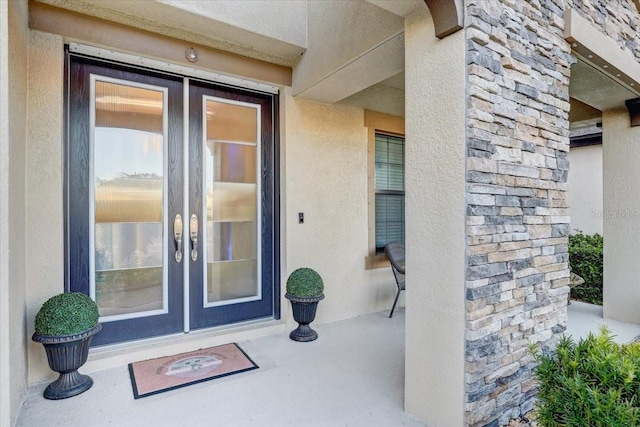 doorway to property with french doors and stucco siding