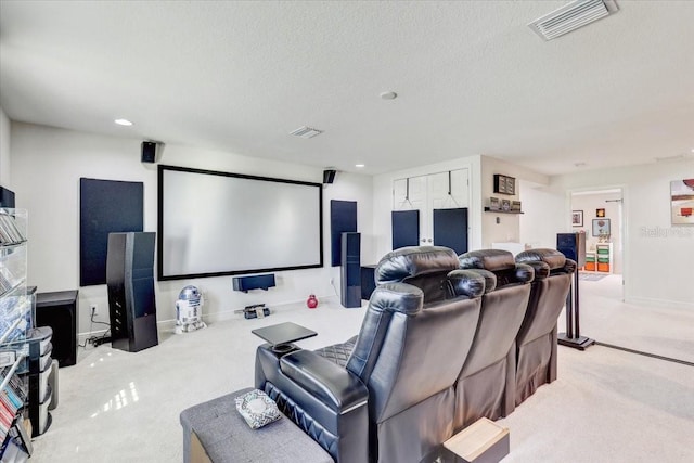 cinema room featuring a textured ceiling, carpet floors, visible vents, and recessed lighting