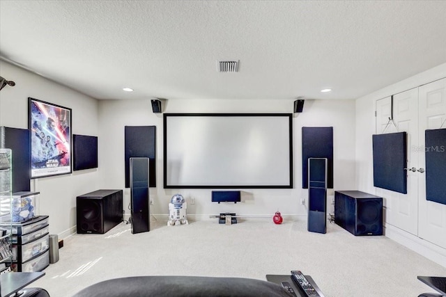 home theater room with a textured ceiling, visible vents, carpet flooring, and french doors