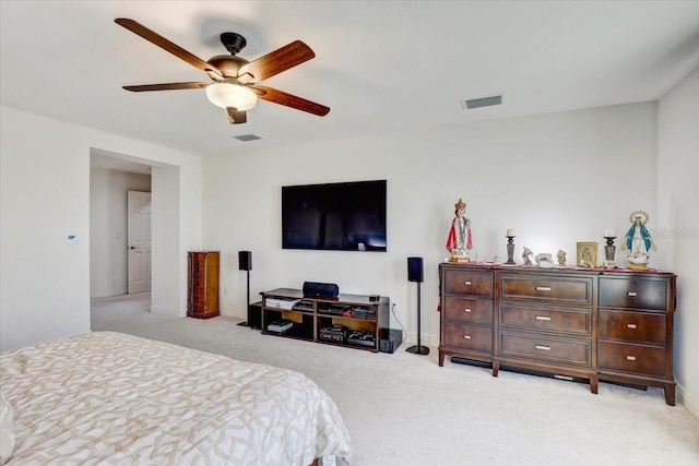 bedroom featuring a ceiling fan, light colored carpet, visible vents, and baseboards