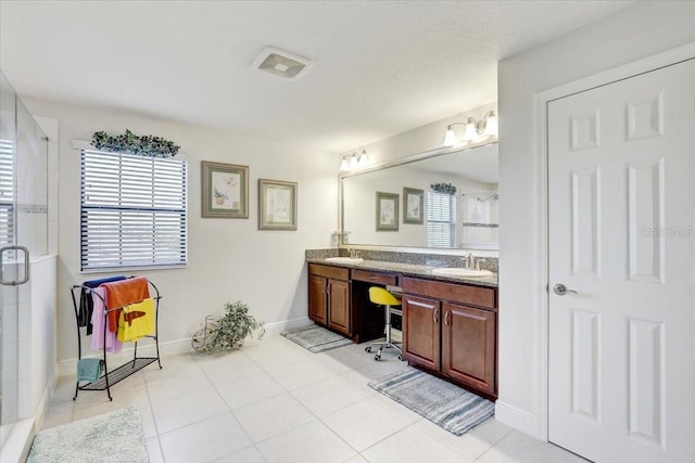 full bath with baseboards, double vanity, a sink, and a shower stall