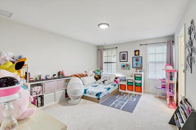 carpeted bedroom with multiple windows, visible vents, and baseboards