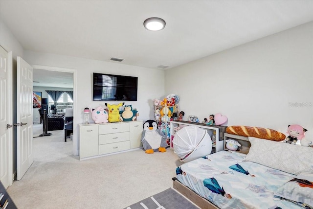 bedroom featuring light carpet and visible vents