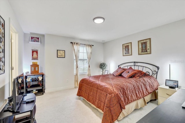 bedroom featuring baseboards and light colored carpet