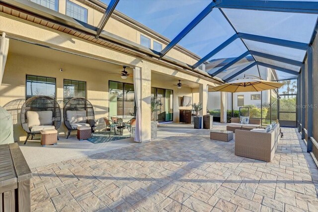 view of patio with a lanai, ceiling fan, and an outdoor hangout area