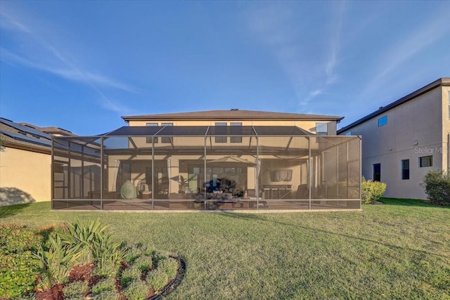 back of property with a yard and glass enclosure