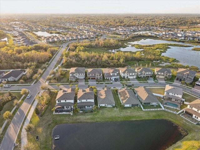 drone / aerial view with a residential view and a water view