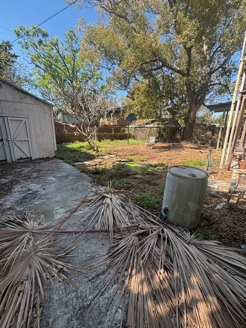 deck with a storage shed, an outdoor structure, and fence