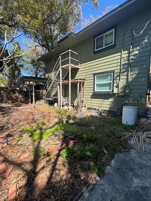 back of property featuring stairway