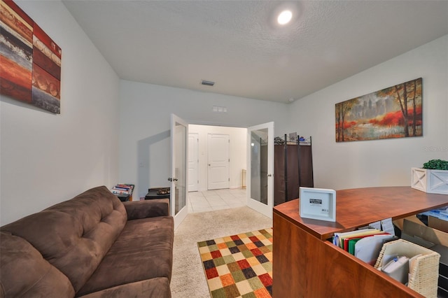 carpeted office with a textured ceiling, french doors, and visible vents