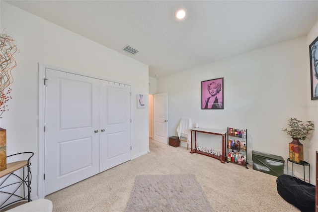 interior space with carpet flooring and visible vents