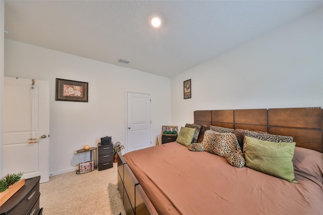 bedroom with visible vents and light colored carpet