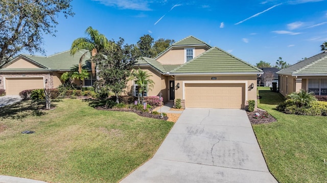 view of front of house featuring a front lawn, a tile roof, concrete driveway, stucco siding, and a garage