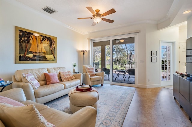 living room featuring visible vents, ornamental molding, a ceiling fan, light tile patterned flooring, and baseboards