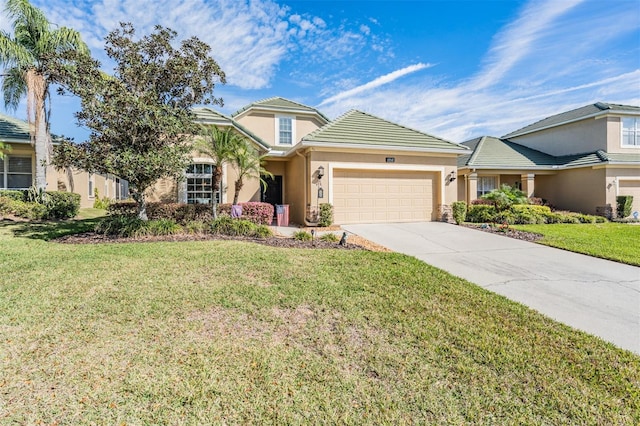 view of front of home with driveway, stucco siding, a front lawn, a garage, and a tiled roof