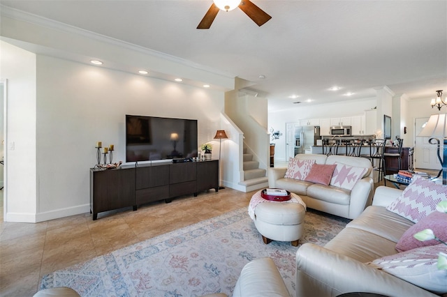 living room featuring stairway, baseboards, recessed lighting, crown molding, and ceiling fan with notable chandelier