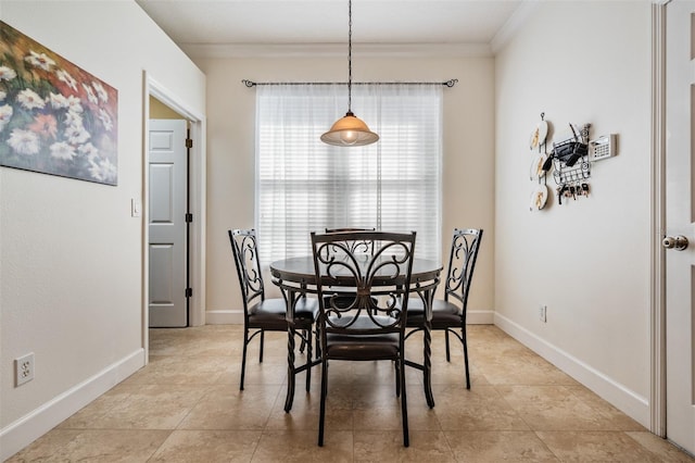 dining space with baseboards, ornamental molding, and light tile patterned flooring