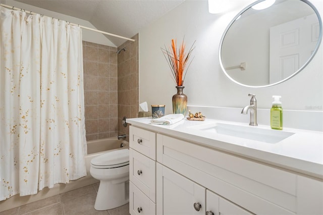 bathroom with vanity, tile patterned flooring, shower / bath combo with shower curtain, a textured ceiling, and toilet