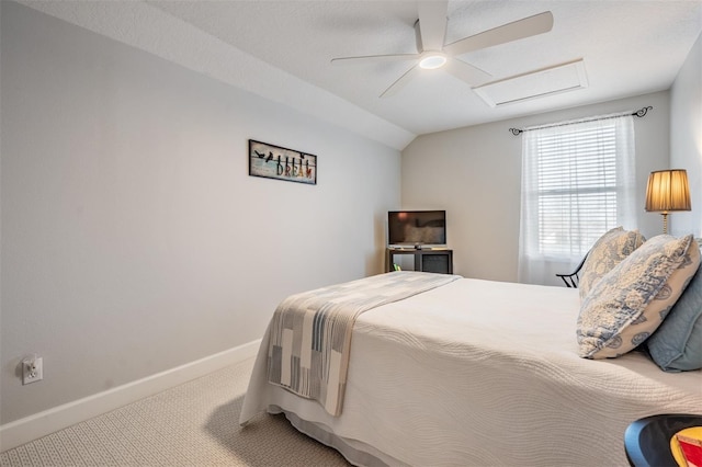 carpeted bedroom with baseboards, attic access, ceiling fan, and vaulted ceiling